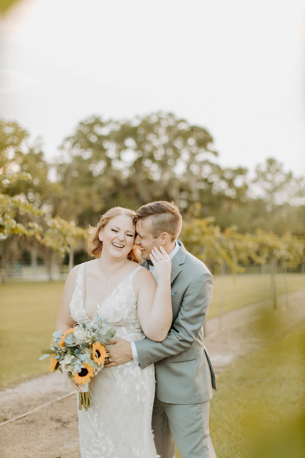 groom holds bride in vineyards at ever after farms