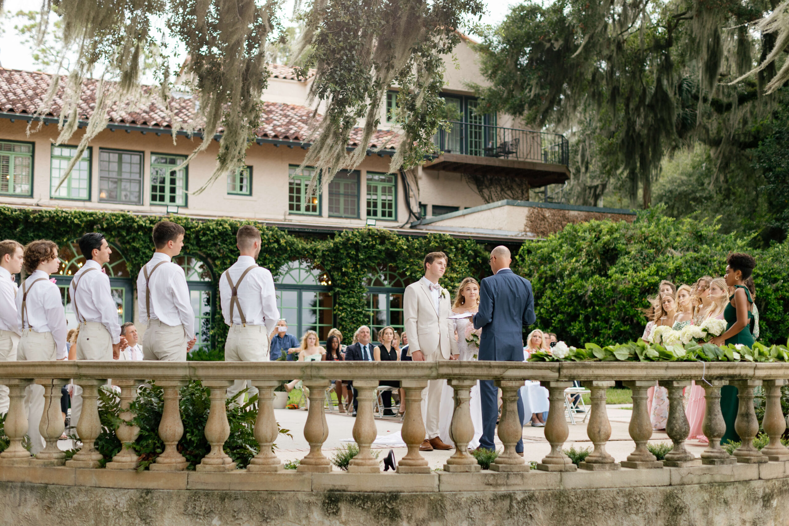 bride and groom stand at ceremony at club continental wedding