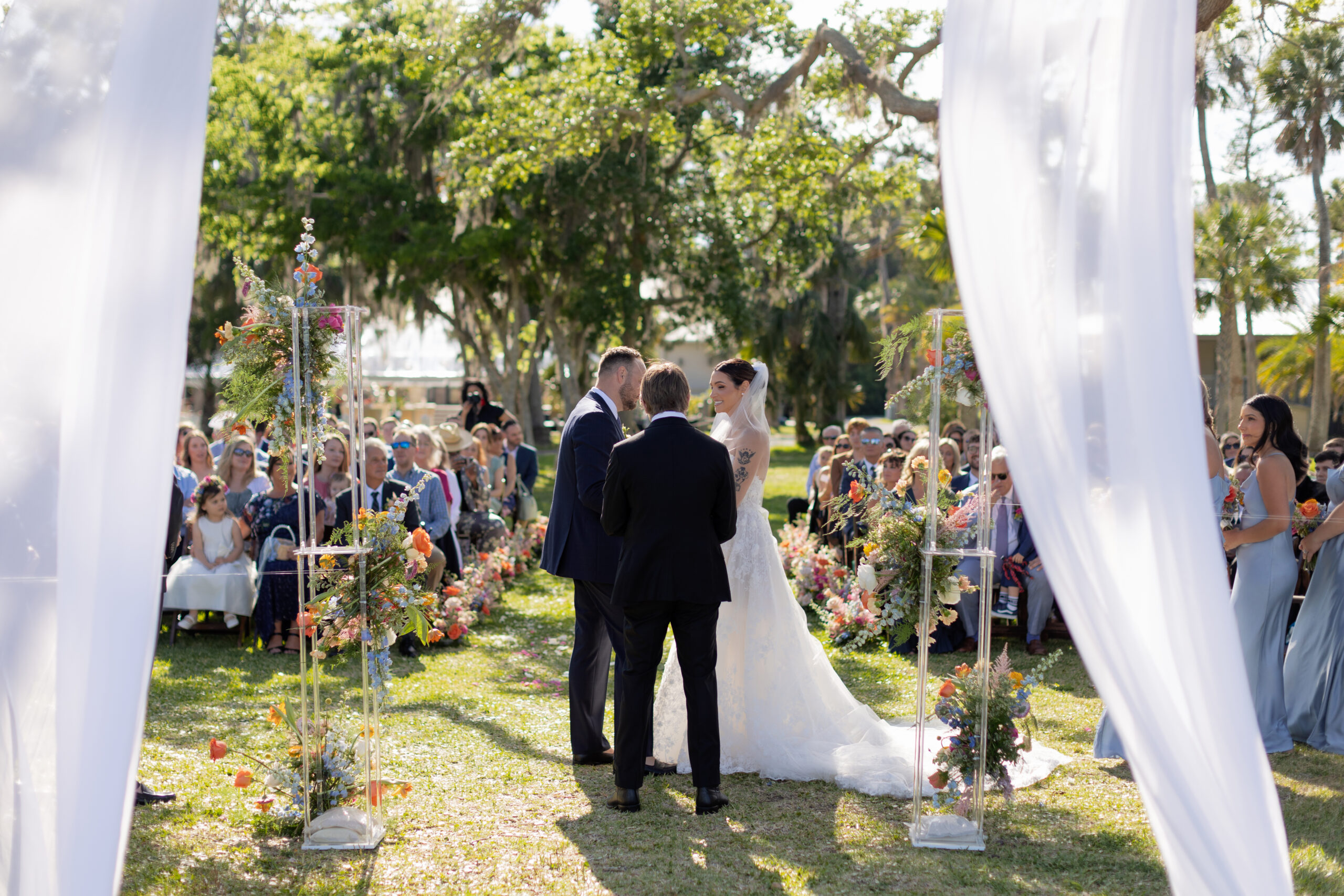 bride and groom stand at alter in front of guest in photo taken by shandi lynn photo