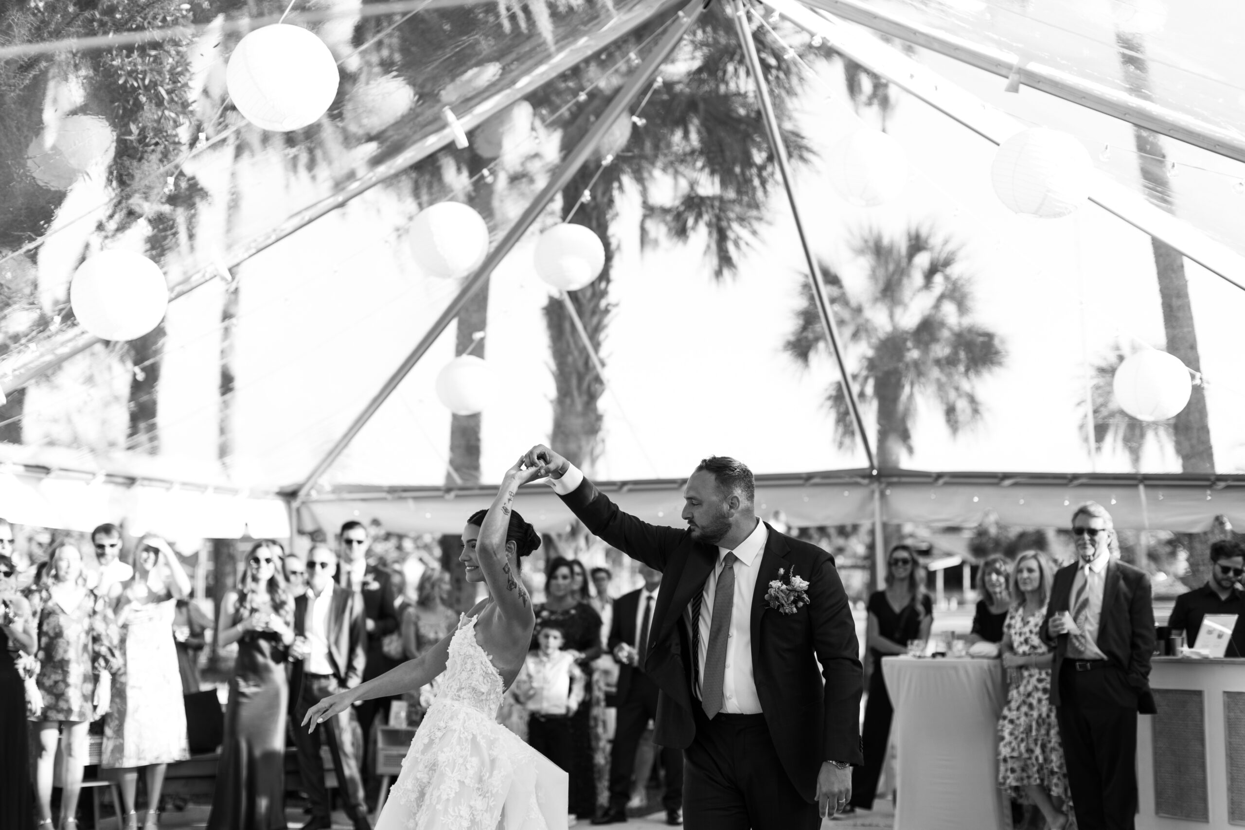 groom spins bride while dancing at wedding reception