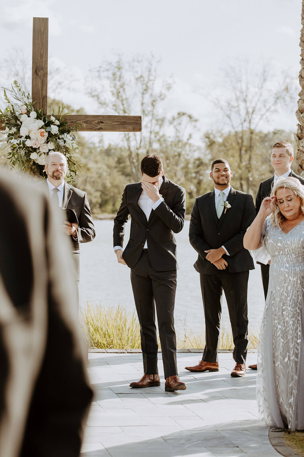 groom cries at wedding alter