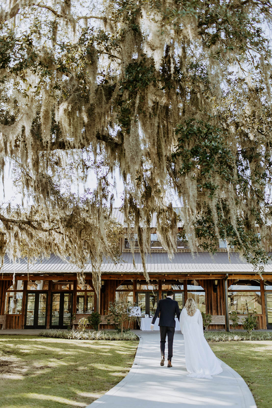 bride and groom walk into the barn at cottonwood ranch