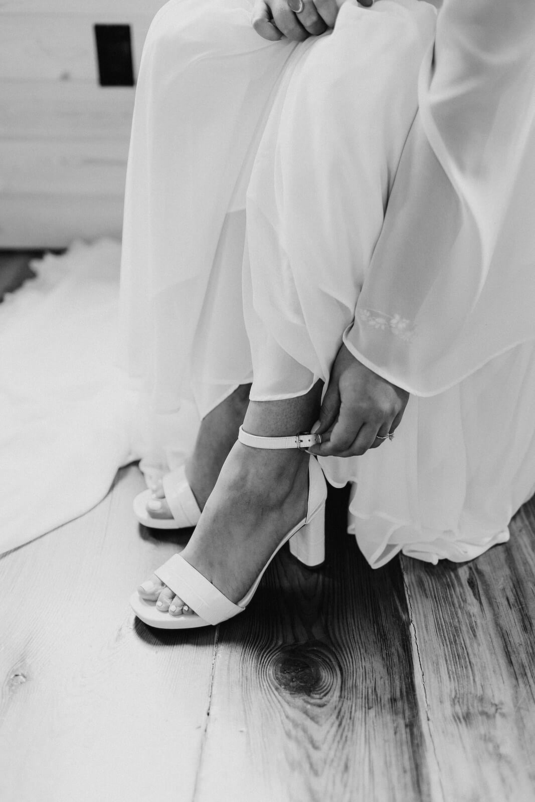 bride putting heels on