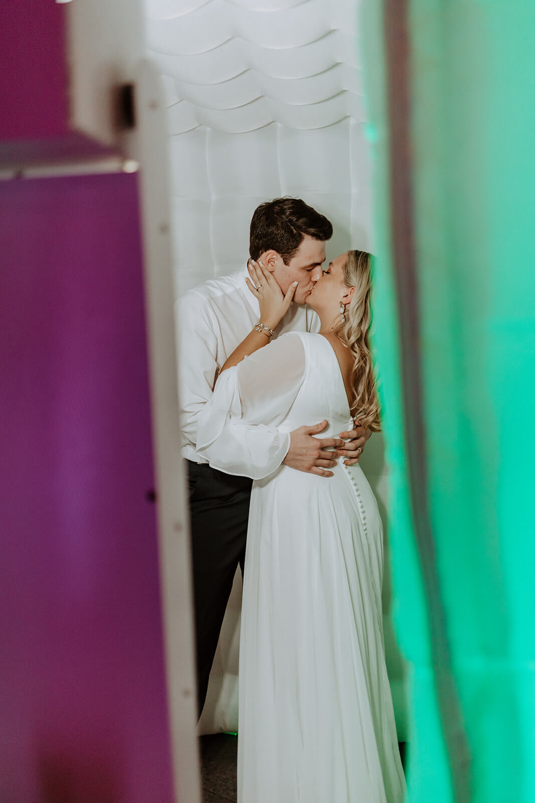 bride and groom kiss in photo booth
