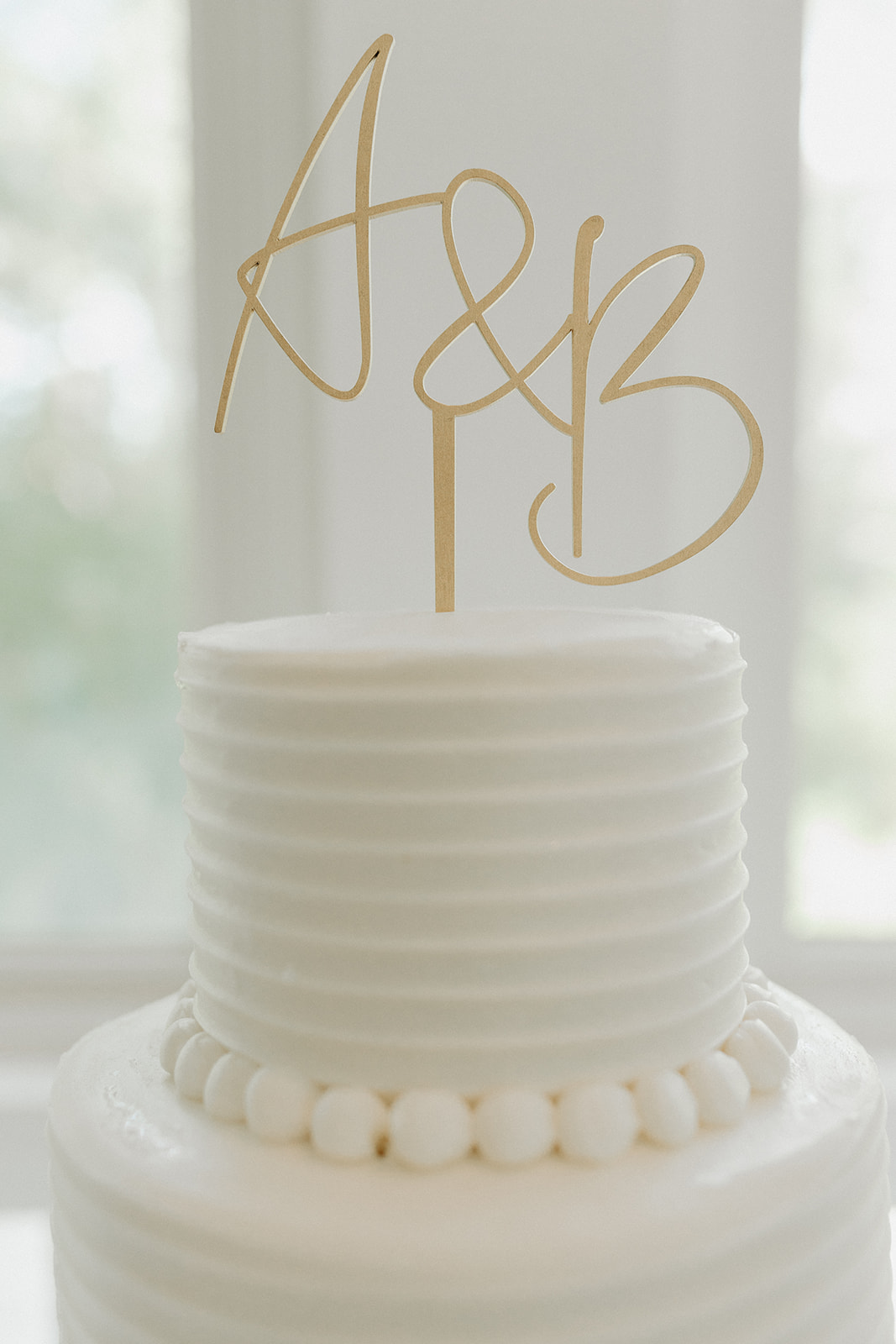 white wedding cake with a&b caketopper