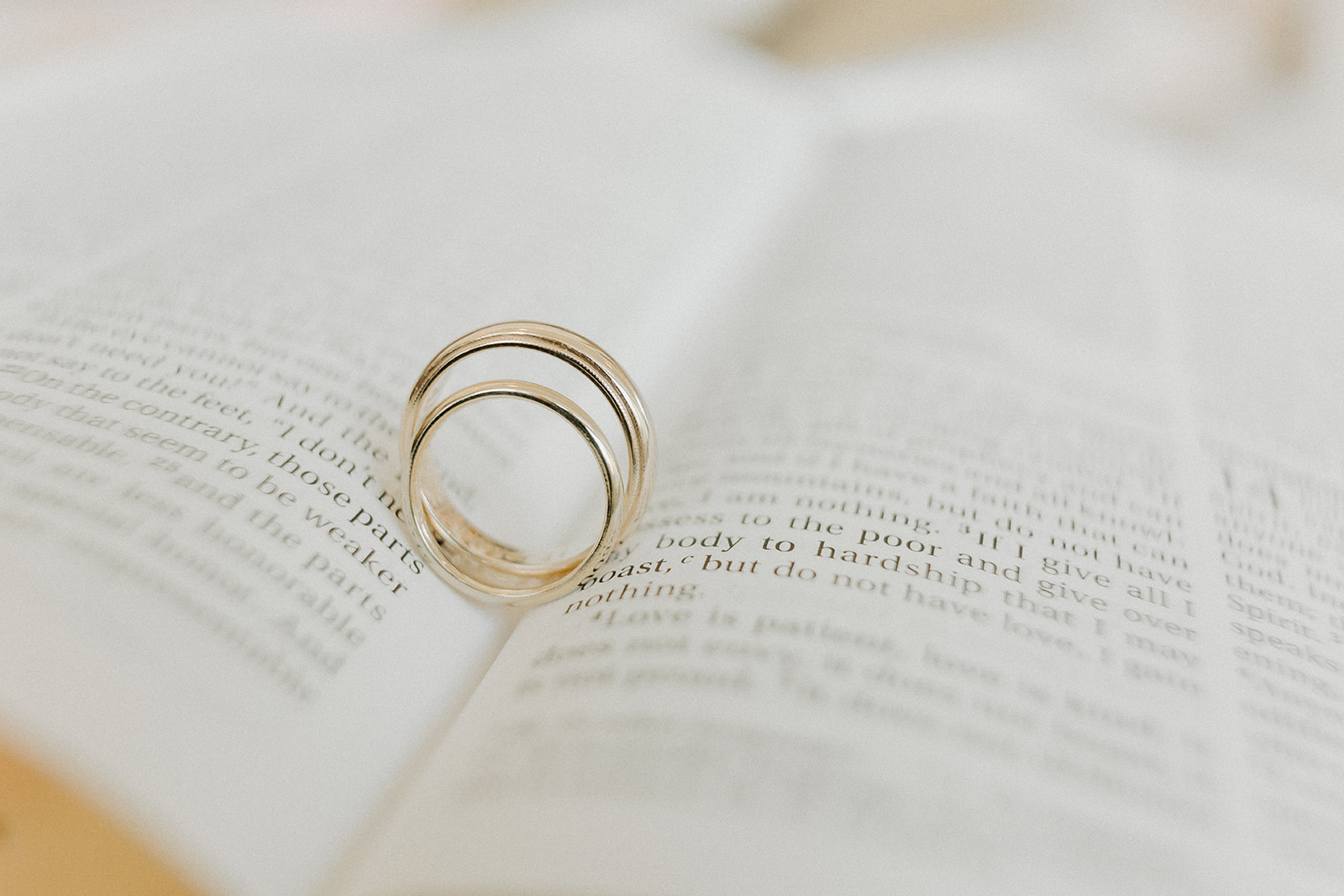 close up image of wedding rings on a bible