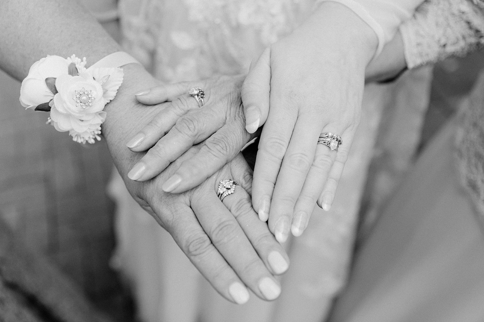three womens hands with wedding rings