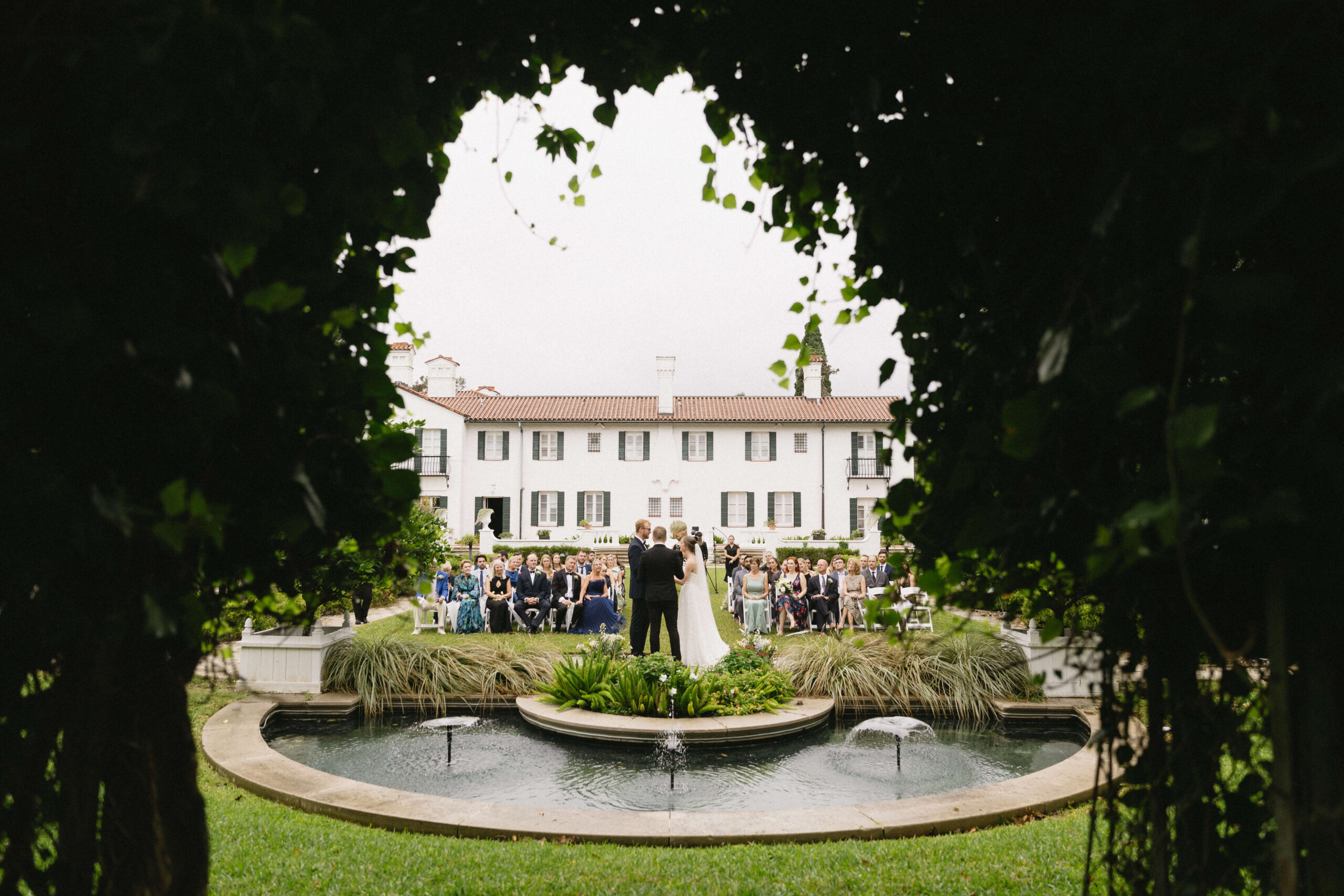 bride and groom stand at ceremony at crane cottage