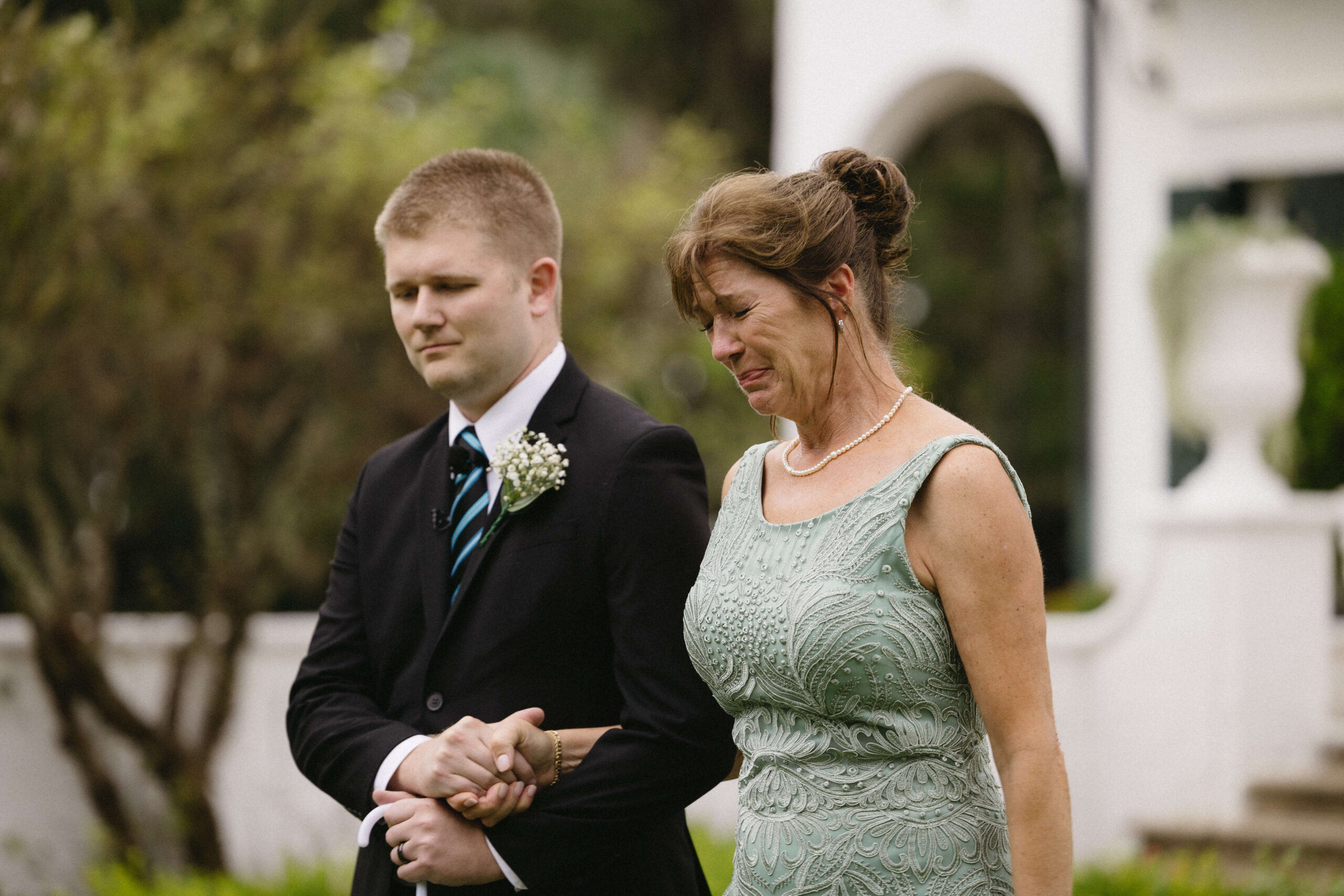 women crying while holding mans hand