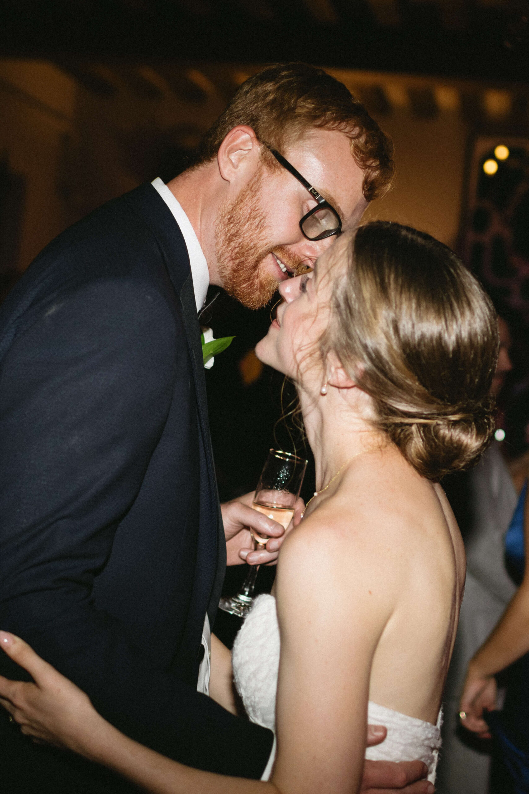 bride and groom embracing at wedding reception