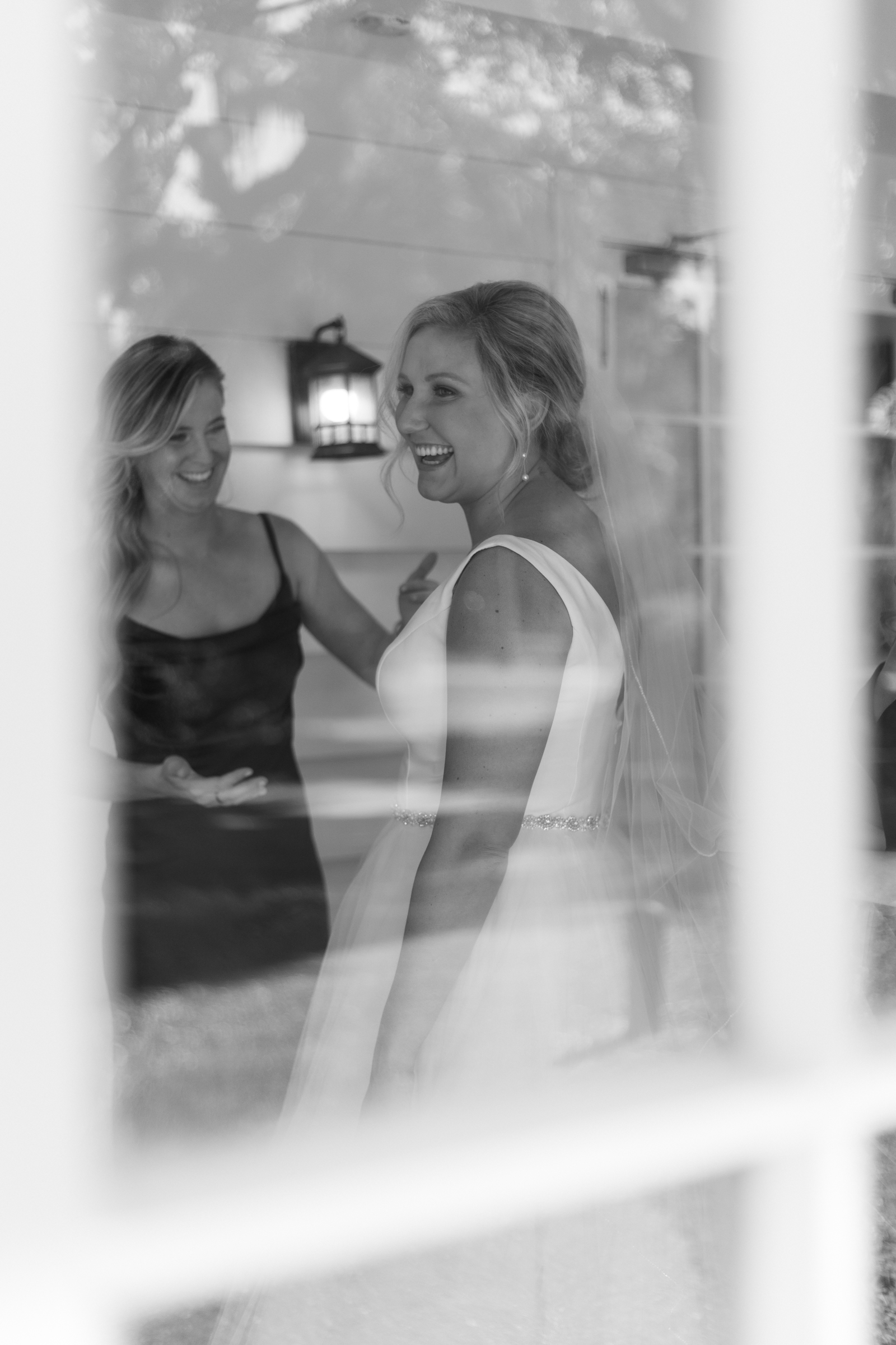 bride smiling through window of the ribault club jacksonville fl wedding venue