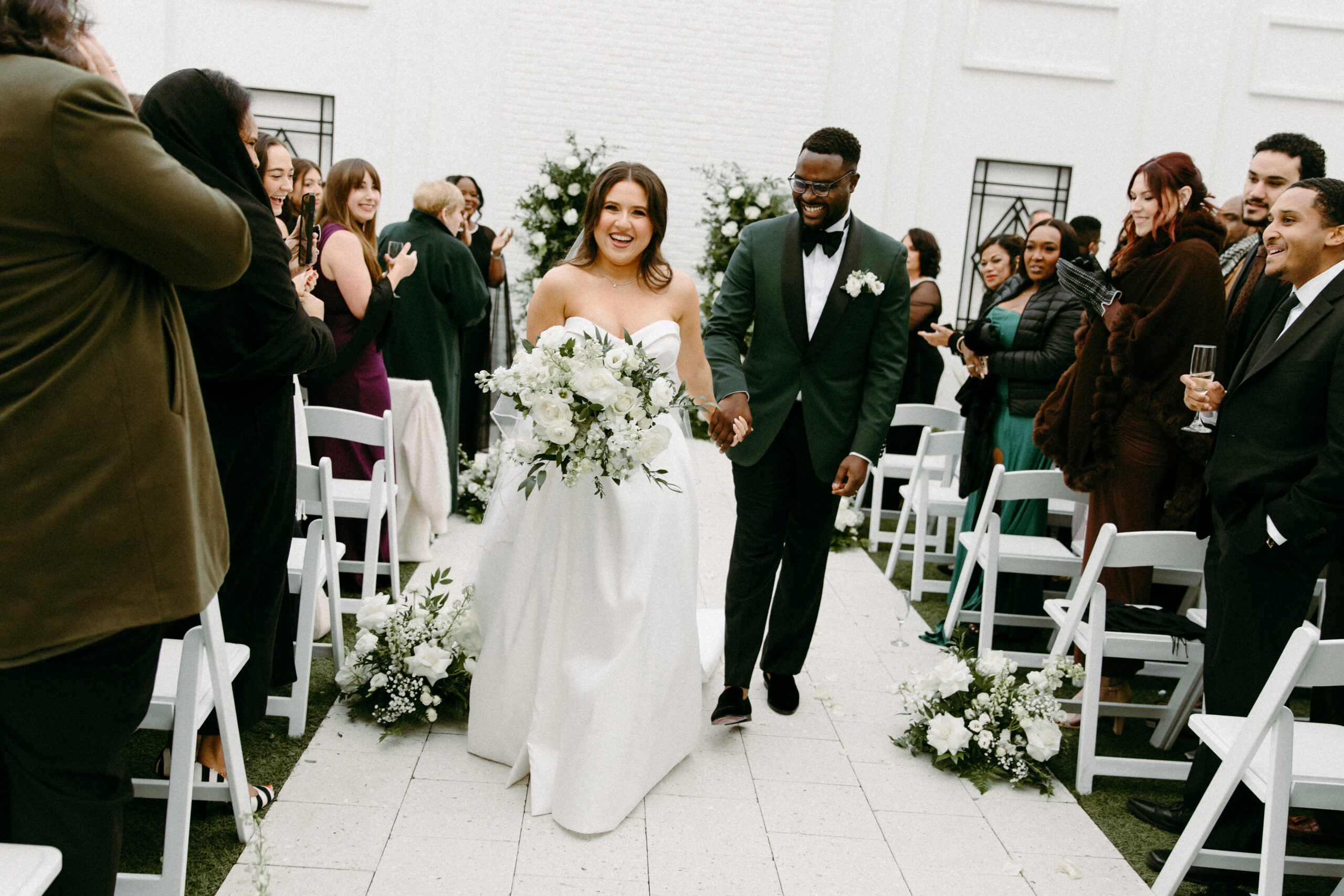 bride and groom walk down aisle at clay theatre wedding venue, taken by shandi lynn photo