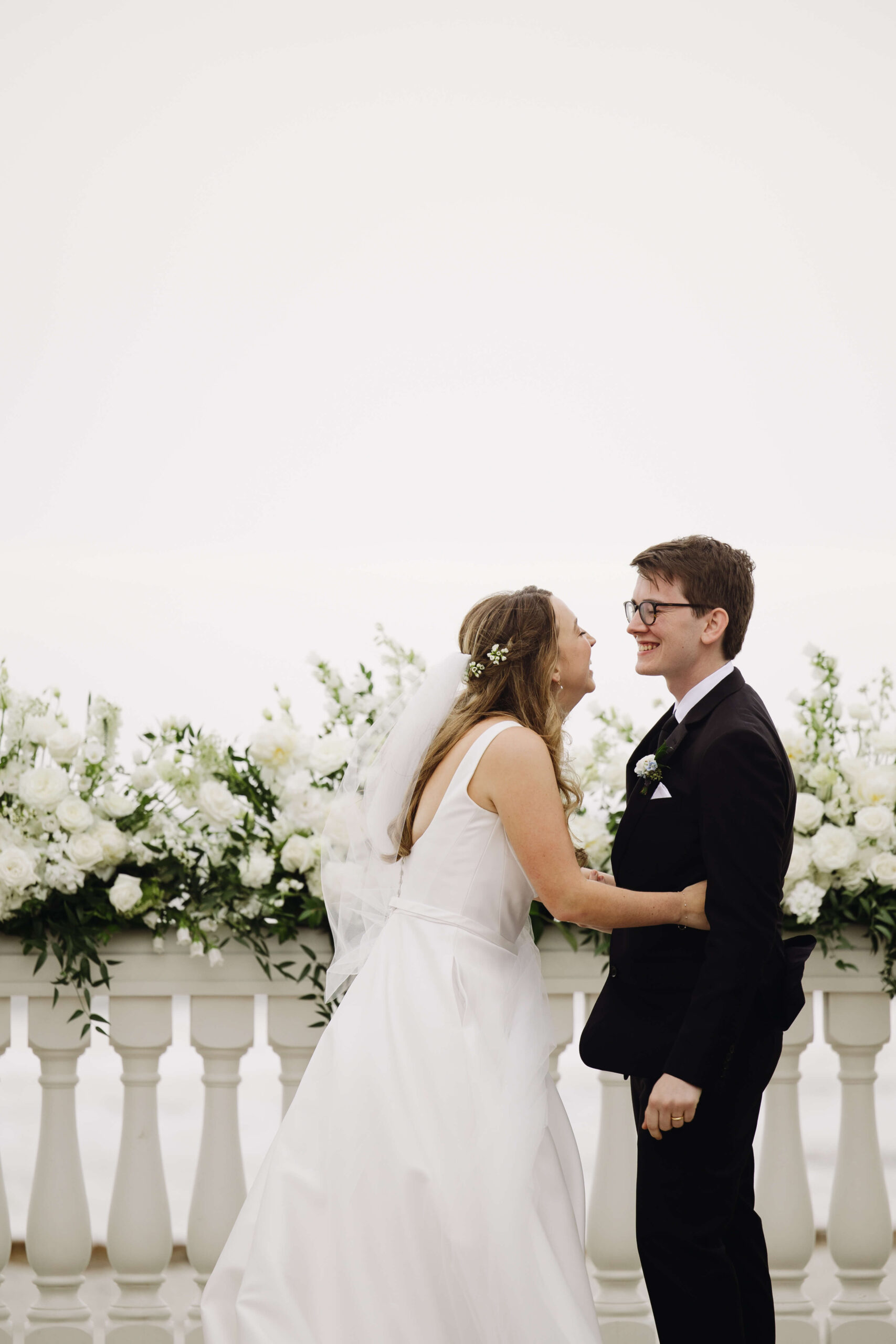 bride and groom laughing at wedding alter
