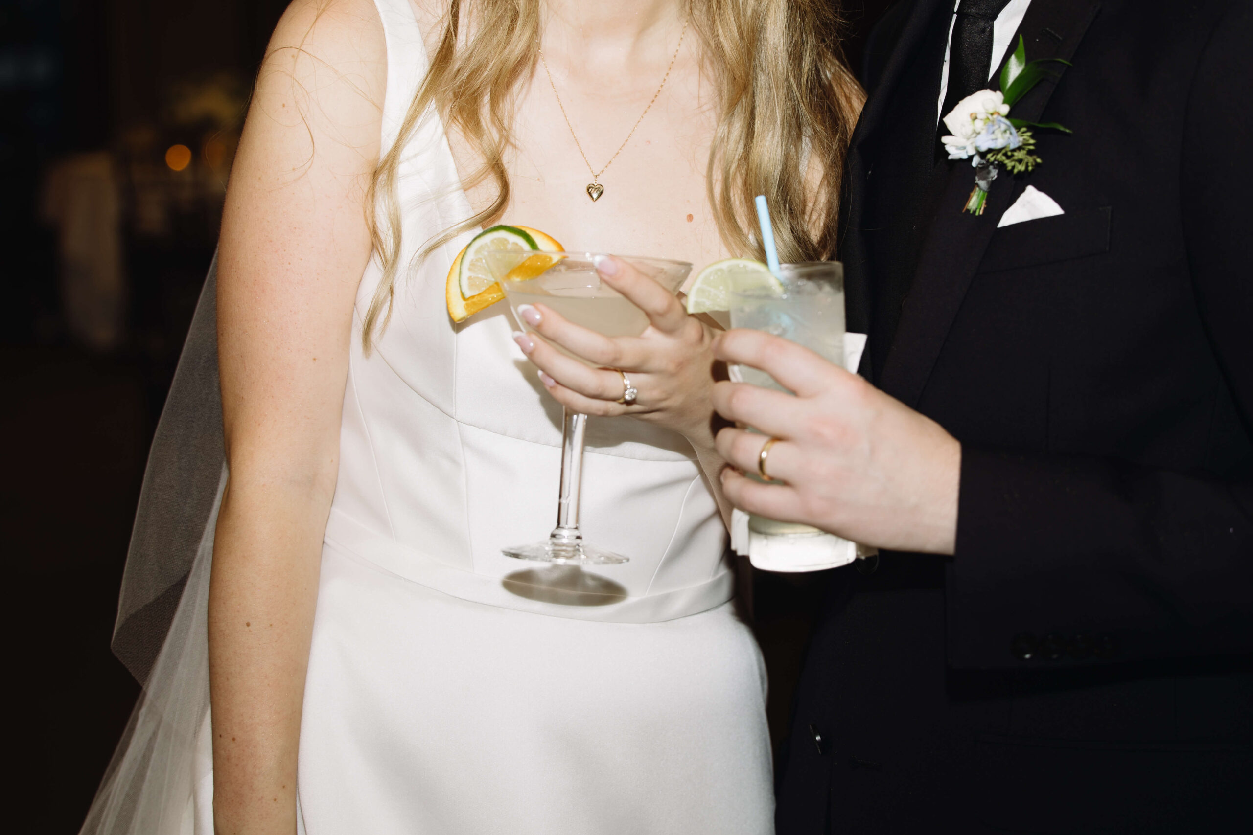 bride and groom holding wedding cocktails