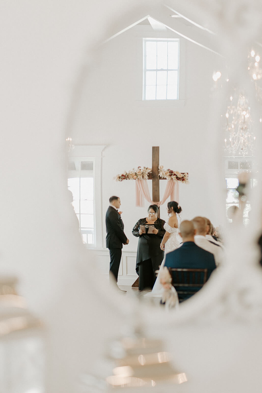 bride and groom stand at wedding alter at the white room in st augustine