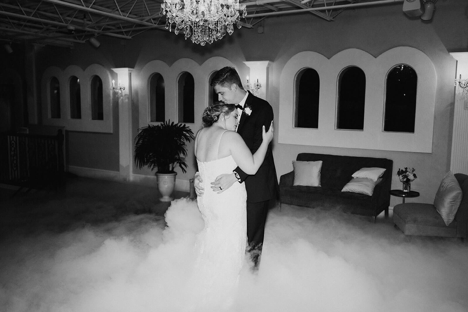 bride and groom dance together at wedding reception