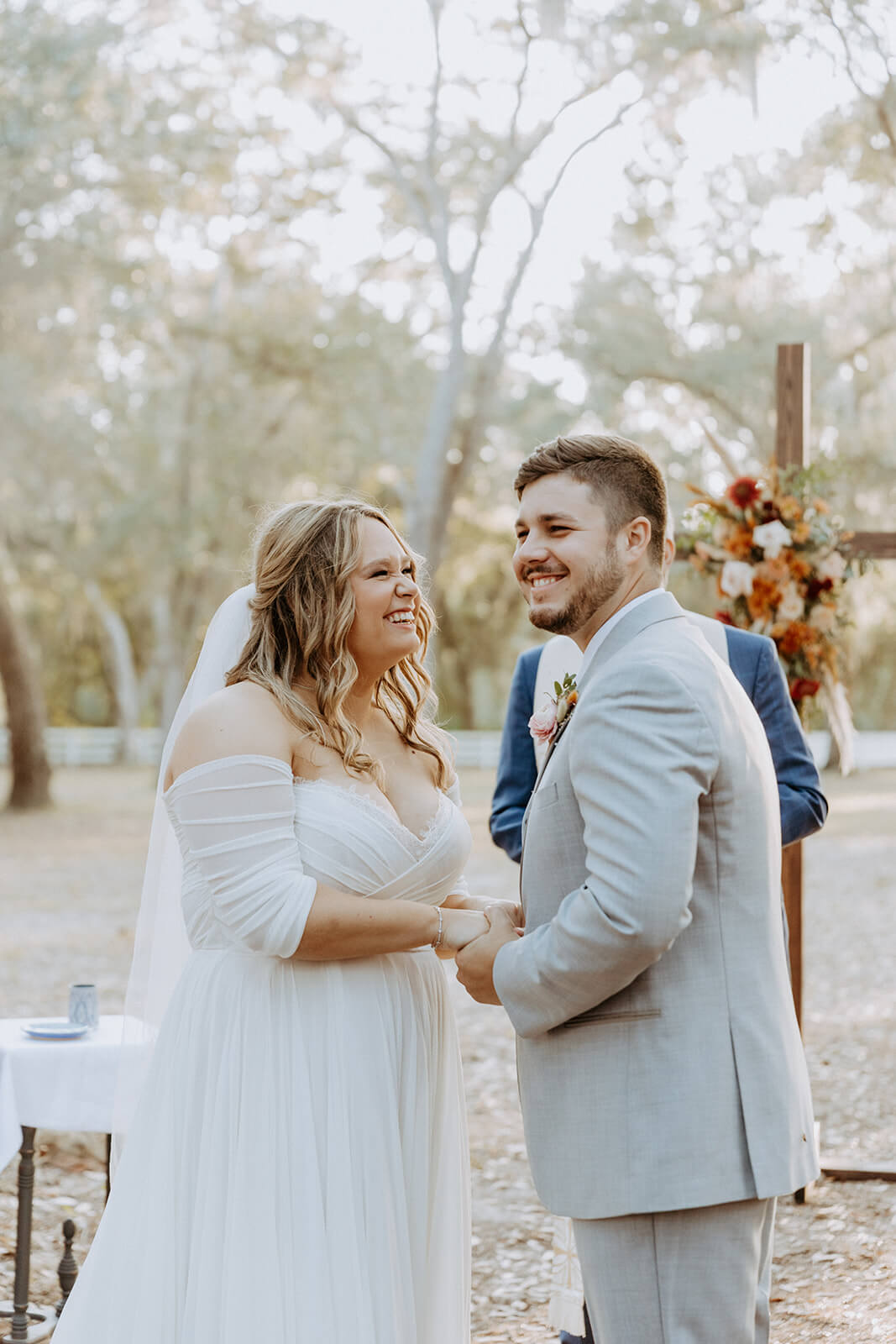 bride and groom laugh together at chandler oaks farm wedding ceremony