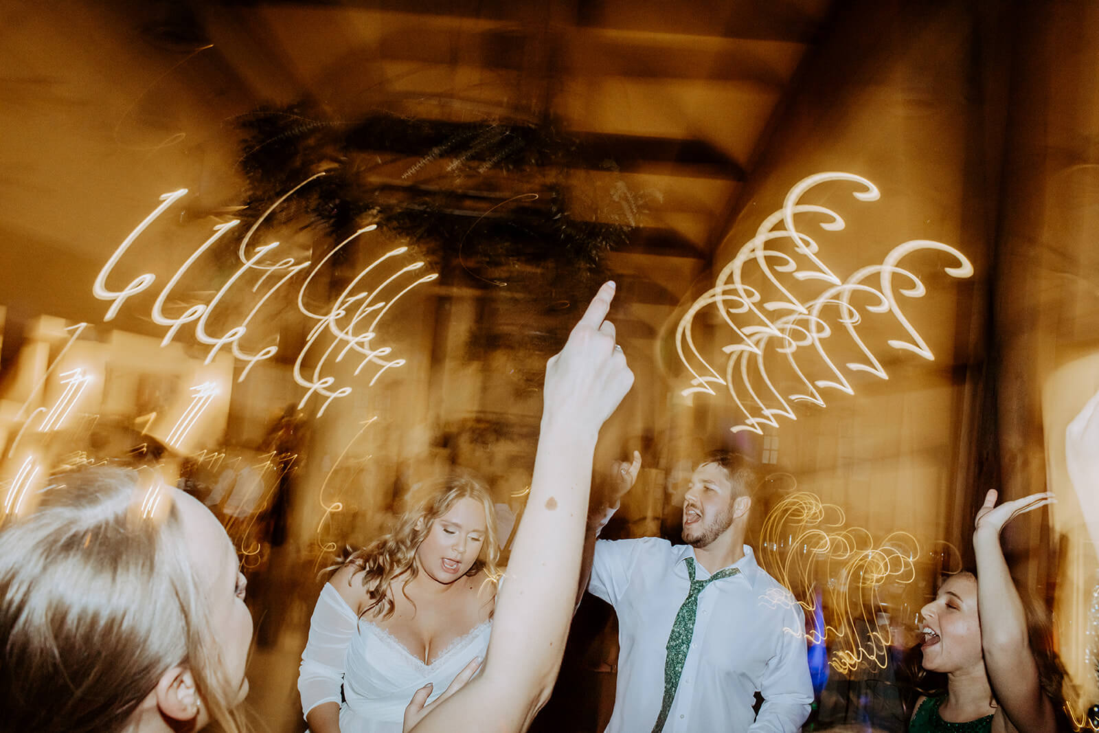 bride and groom dance with guests at barn wedding reception